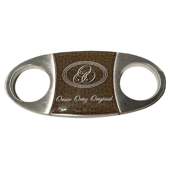 Omar Ortez steel cigar cutter with stainless steel blades and brown center panel displayed on white background